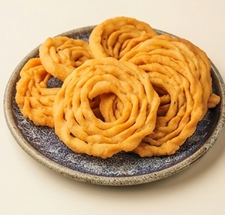 Kaimurukku stacked on a brass plate
